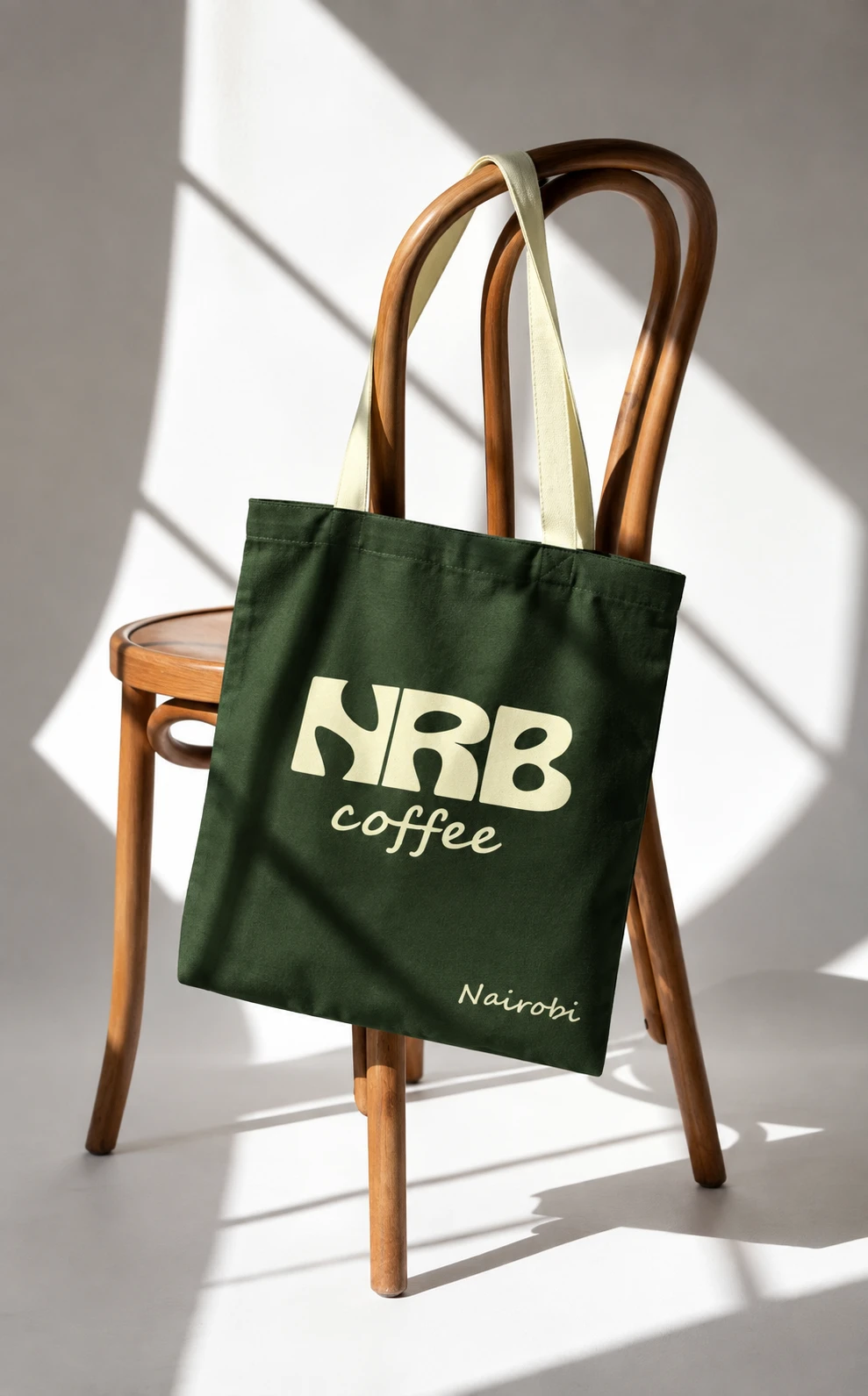 Olive NRB tote concept on a wooden chair in soft light